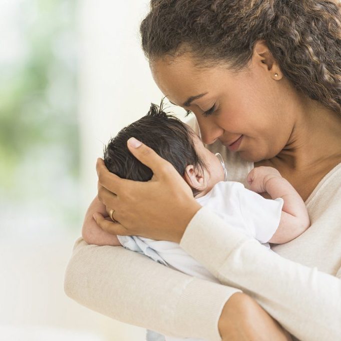 Hispanic mother holding infant son